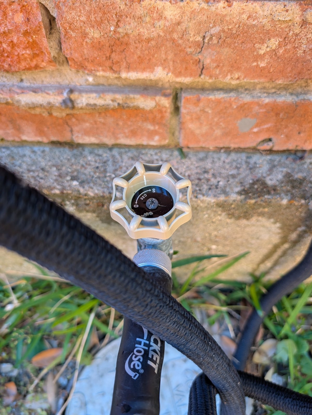 Outdoor spigot and faucet replacement on brick exterior