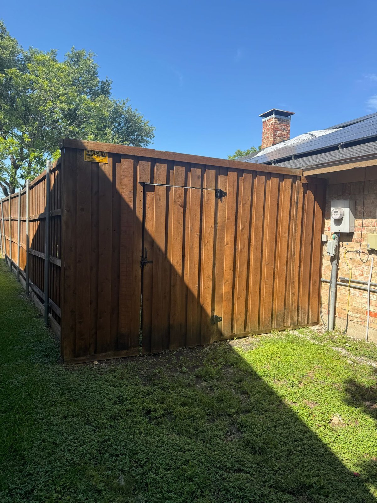 Stained wood fence with gate in Dallas neighborhood