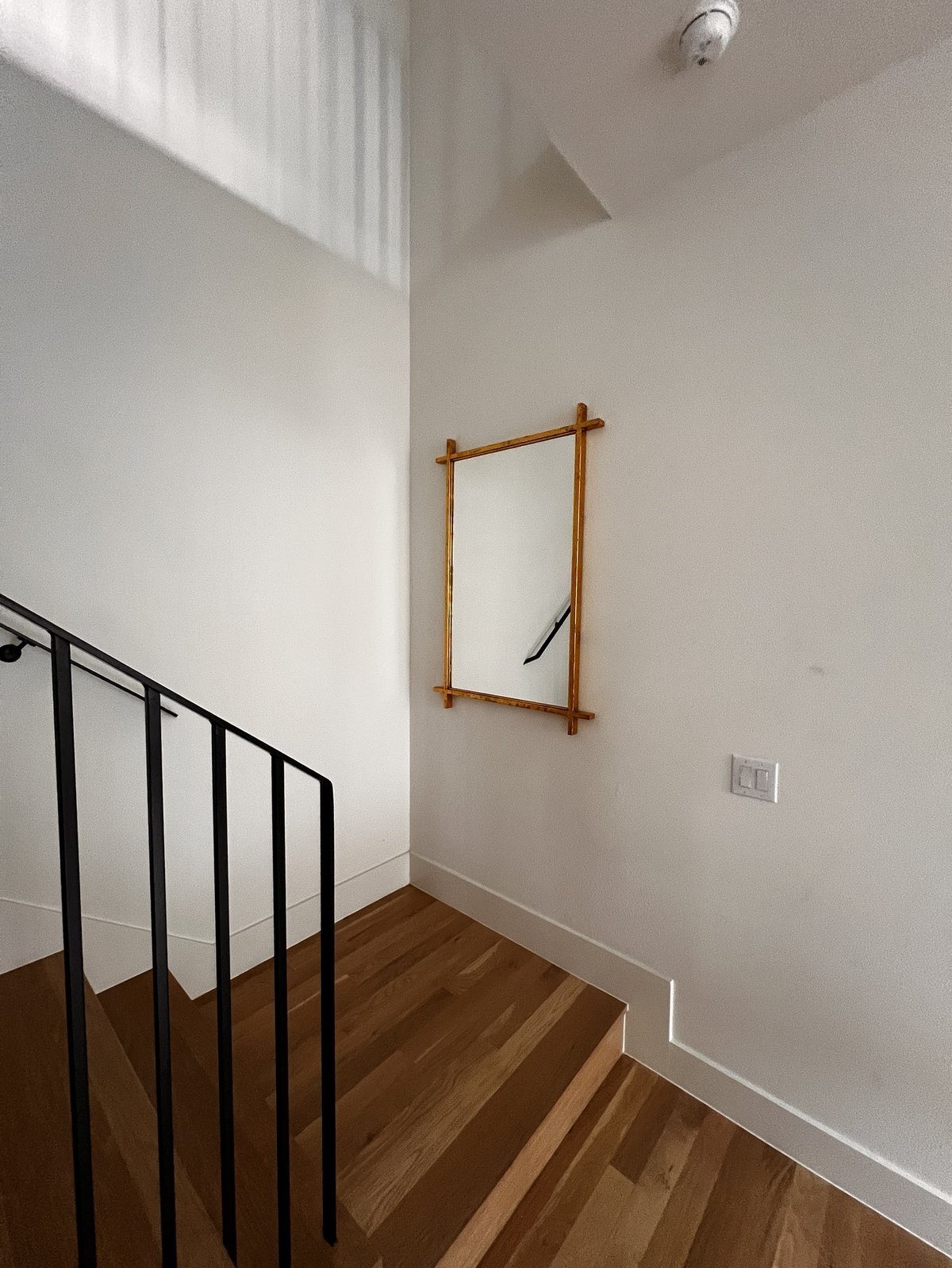 Large mirror professionally hung on wall in Dallas home