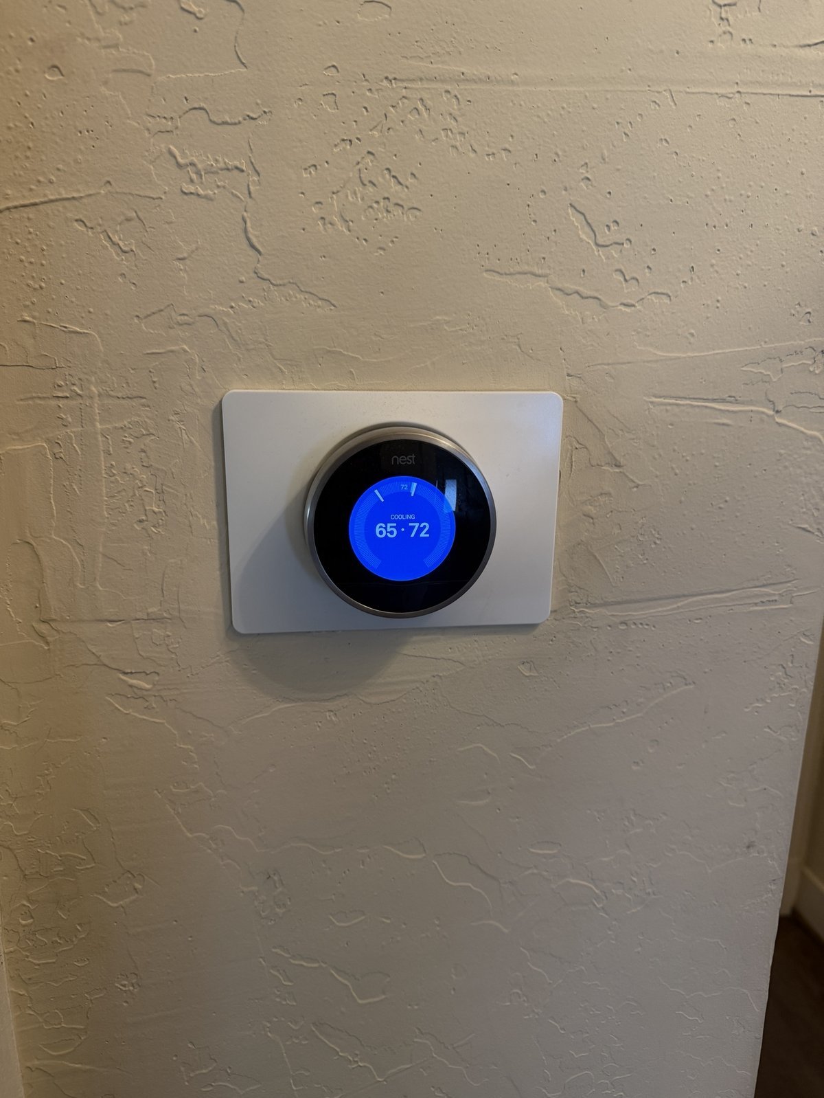 Smart thermostat installed on wall in Dallas home