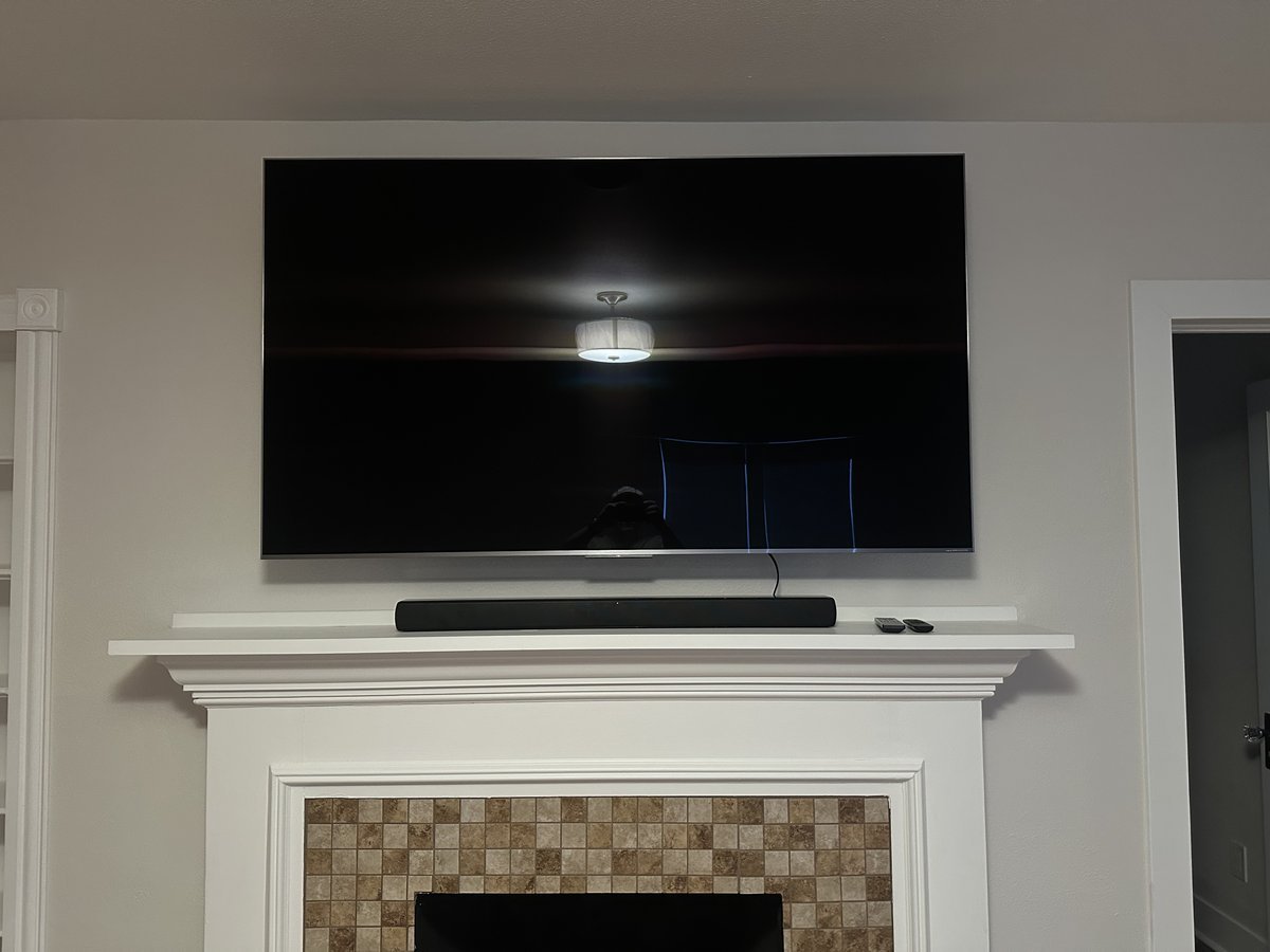 TV mounted on wall with hidden wire concealment in Dallas home